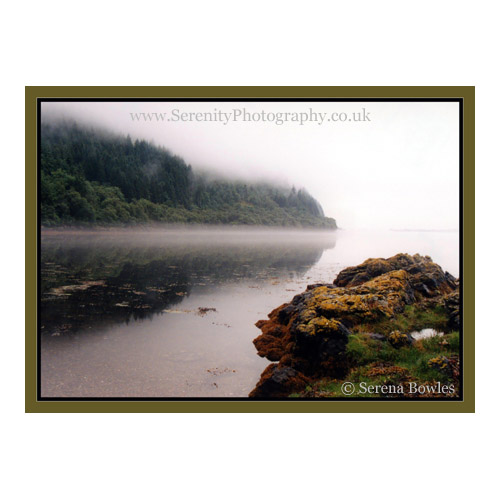 A morning mist shrouds a Scottish Loch.